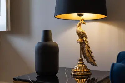 a lamp sitting on a table next to a vase at Glamour by the River in Porto