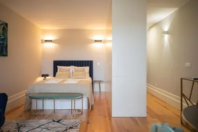 a bedroom with a bed and two tables at Glamour by the River in Porto