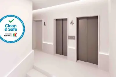 a room with three elevator doors in a building at Studio Jardim São Lázaro in Porto