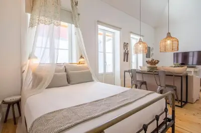 a bedroom with a bed and a dining room at 157 Flores Apartment in Porto