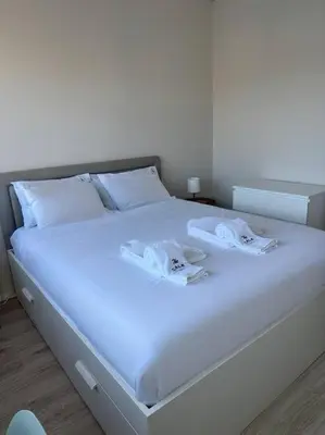 a white bed with white sheets and towels on it at The Cale - Porto, Sá da Bandeira in Porto