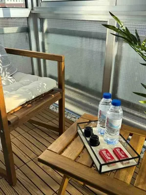 a table with two bottles of water on a balcony at The Cale - Porto, Sá da Bandeira in Porto