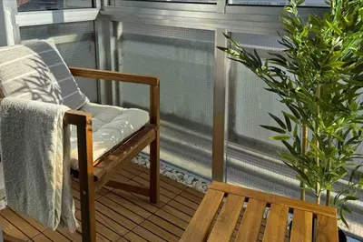 a rocking chair on a balcony with a bench at The Cale - Porto, Sá da Bandeira in Porto