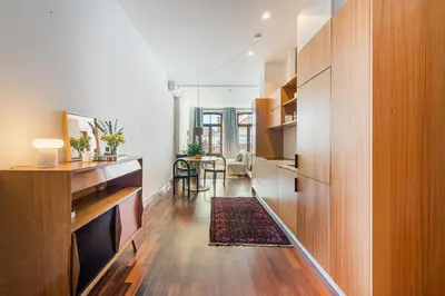 a living room with wooden cabinets and a dining room at Hey Apartments C in Porto