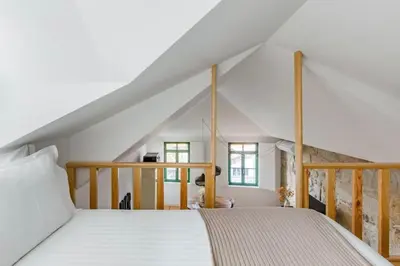 a bedroom with a large bed in a attic at 1892 - Ribeira Loft in Porto