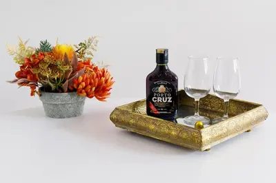 a bottle of wine and two glasses on a gold tray at Oporto Cosy Apartment in Porto