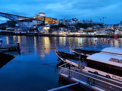 a boat docked in a harbor with a city in the background at Oporto Cosy Apartment in Porto