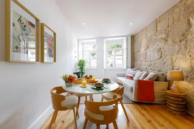 a living room with a table and a couch at Oporto Cosy Apartment in Porto