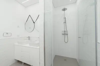 a white bathroom with a shower and a sink at Modern Villa by Hosty in Porto