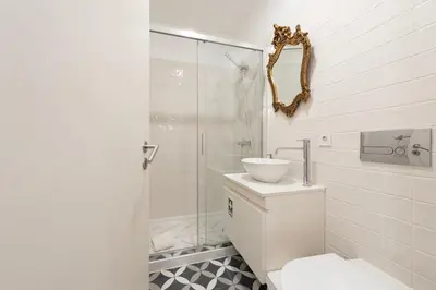 a bathroom with a toilet and a sink and a shower at Mouzinho Rooftop View in Porto