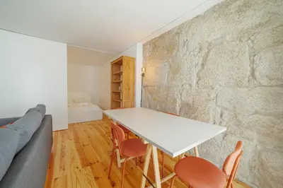 a living room with a white table and chairs at Cozy Almada by Hosty in Porto
