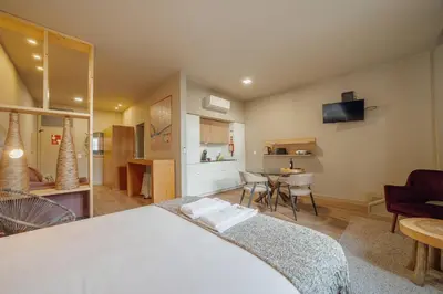 a bedroom with a bed and a living room at Flores Deluxe by Hosty in Porto