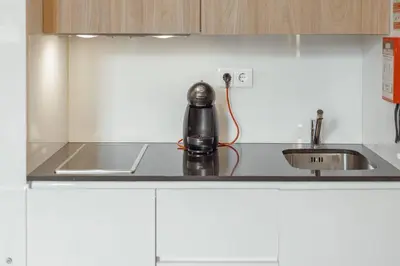 a tea kettle on a counter in a kitchen at Flores Deluxe by Hosty in Porto