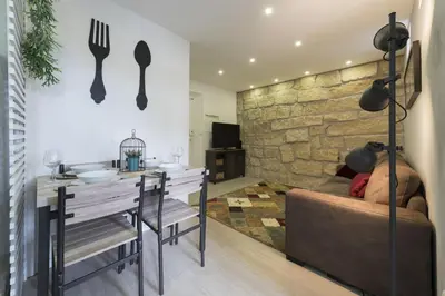 a living room with a table and a couch and a dining room at Santo Ildefonso RicaHouses in Porto