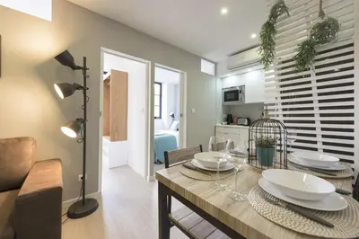 a dining room with a table and a living room at Santo Ildefonso RicaHouses in Porto
