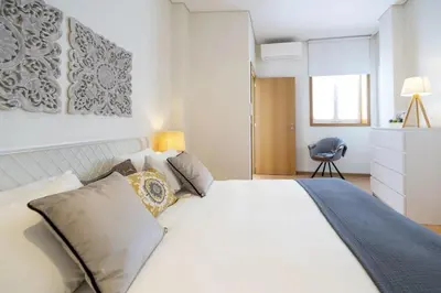 a living room with a white couch and a dresser at Modern Living - Santa Catarina in Porto