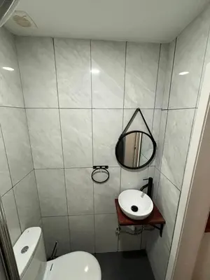 a bathroom with a sink and a toilet and a mirror at Bonsai Apartment 5 in Porto