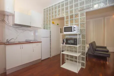 a small kitchen with a microwave and a refrigerator at Bonsai Apartment 5 in Porto