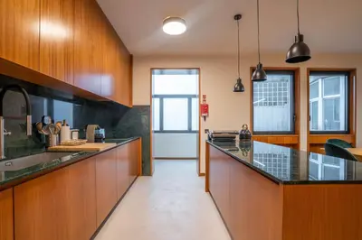 a large kitchen with wooden cabinets and a counter top at Sublime Downtown Retreat by ELSA, 180m2 in Porto