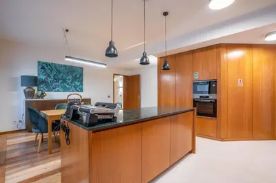 a kitchen with wooden cabinets and a counter top at Sublime Downtown Retreat by ELSA, 180m2 in Porto