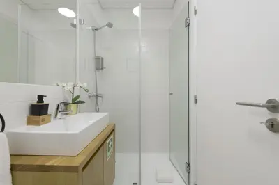 a bathroom with a sink and a shower at S. Bento Downtown Apt in Porto