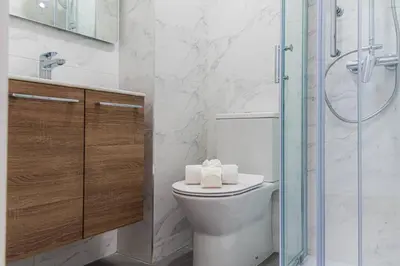 a bathroom with a toilet and a glass shower at Morro Garden Apartment by Hosty in Vila Nova de Gaia