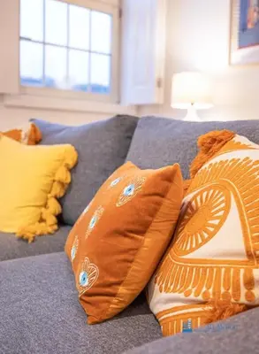 a group of pillows on a blue couch at Porto Cedofeita Art & Design Loft in Porto