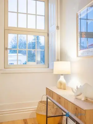 a room with a table with a lamp and a window at Porto Cedofeita Art & Design Loft in Porto