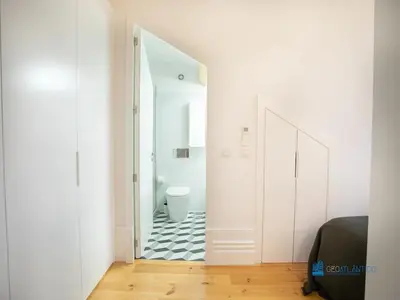 a bathroom with a toilet and a white door at Porto Cedofeita Art & Design Loft in Porto