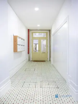 a hallway with a yellow door and a tiled floor at Porto Cedofeita Art & Design Loft in Porto