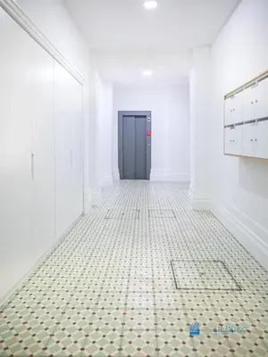 a hallway with a black door and a tiled floor at Porto Cedofeita Art & Design Loft in Porto