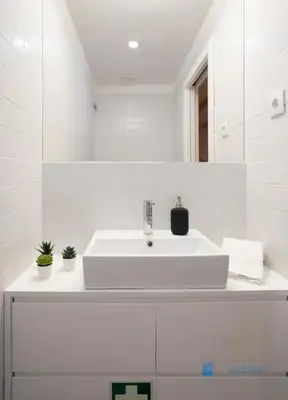 a white bathroom with a sink and a mirror at Porto Cedofeita Art & Design Loft in Porto