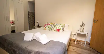 a bedroom with a bed with two pillows on it at Casa do Recanto - Studio in Porto