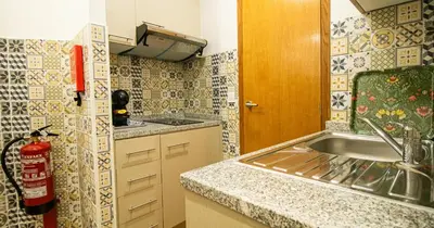 a small kitchen with a sink and a counter at Casa do Recanto - Studio in Porto