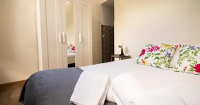 a bedroom with a white bed with towels on it at Casa do Recanto - Studio in Porto