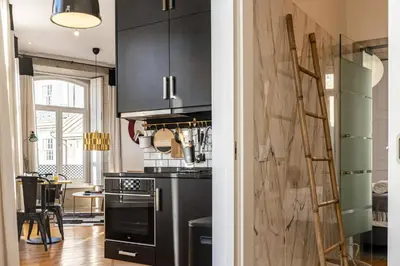 a kitchen with black cabinets and a stove at Mouzinho Penthouse by Hosty in Porto