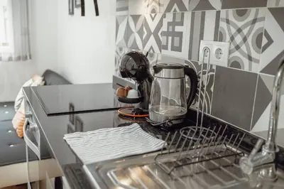 a kitchen counter with a washing machine in a dishwasher at Coliseu Apartment by Hosty in Porto