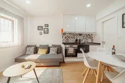 a living room with a couch and a table at Coliseu Apartment by Hosty in Porto