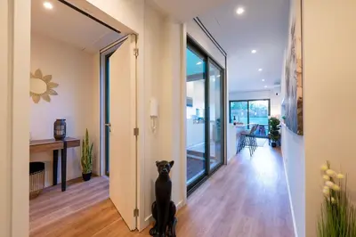 a hallway with a black cat sitting on the floor at Exotic Flat with Shared Pool & Garden in Porto