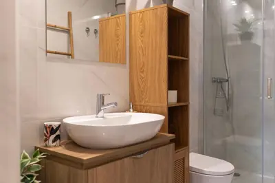a bathroom with a white sink and a shower at Exotic Flat with Shared Pool & Garden in Porto