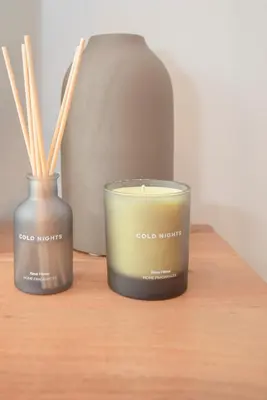 two candles are sitting on a wooden table at NAX Apartments by Liiiving in Porto