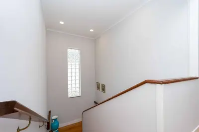 a white room with a staircase and a window at Casinha dos Avós by LovelyStay in Vila Nova de Gaia