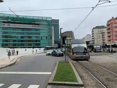 a train is on the tracks in a city at Casinha dos Avós by LovelyStay in Vila Nova de Gaia