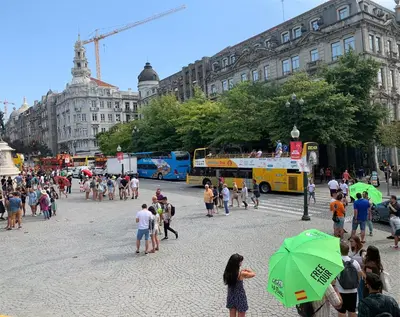 a large group of people walking around a city street at Casinha dos Avós by LovelyStay in Vila Nova de Gaia