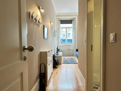 a hallway with a door leading to a bathroom at Art Magellan in Porto