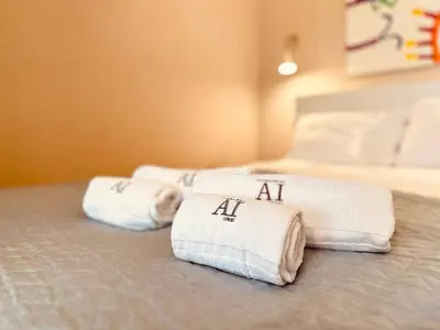 two stacks of towels sitting on a bed at Art Magellan in Porto