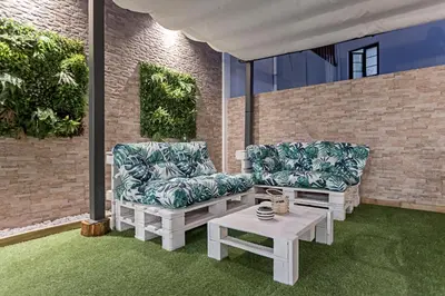 two chairs and a coffee table on a patio at Villa Terra The Garden in Vila Nova de Gaia