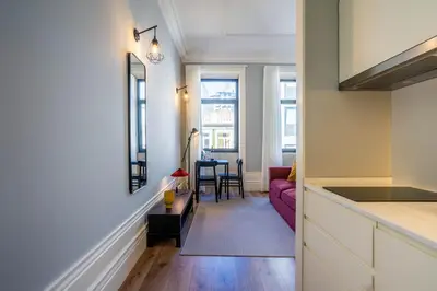 a kitchen and living room with a purple couch at Sta Catarina 632 by LovelyStay in Porto
