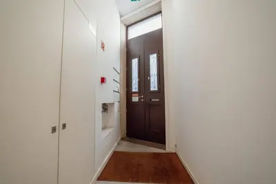 a hallway with a brown door and a window at Formosa Deluxe by Hosty in Porto