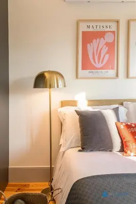 a bedroom with a bed with a lamp next to it at Boavista Charm Balcony Loft in Porto
